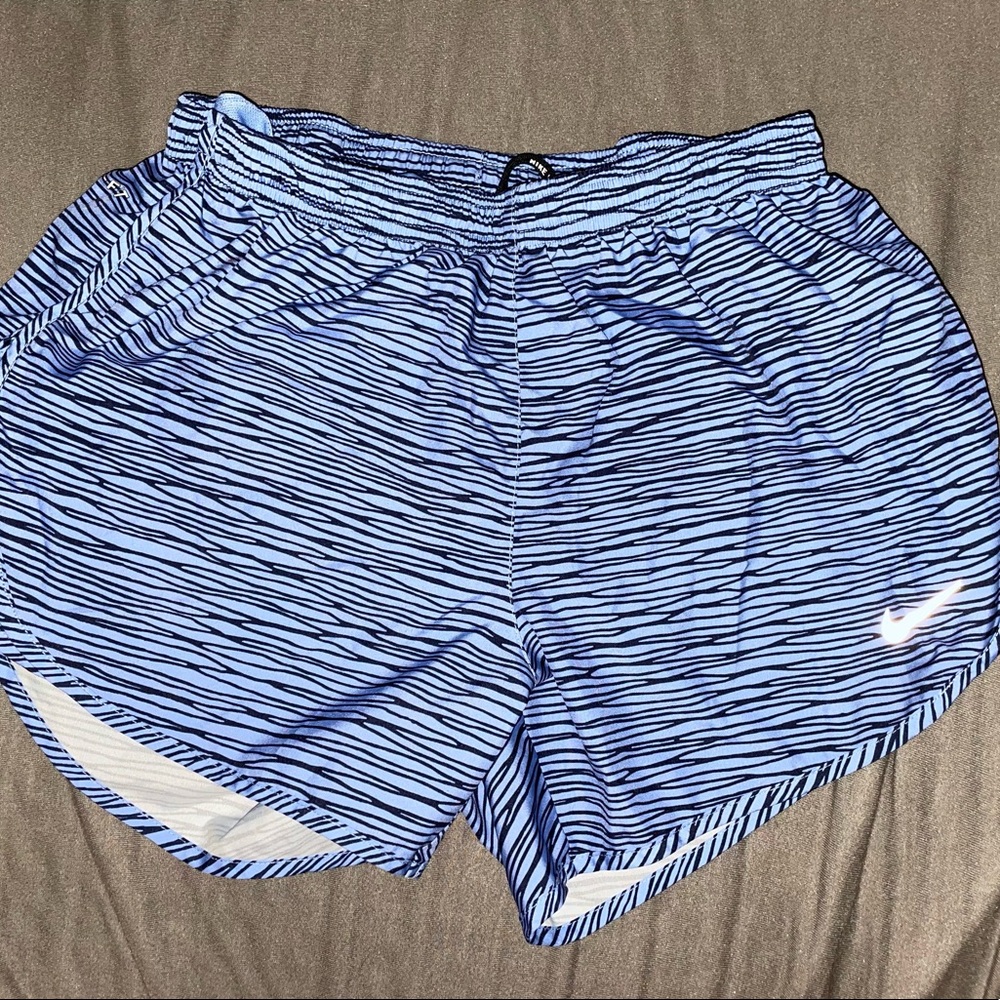 Blue Nike running shirts with black stripes
